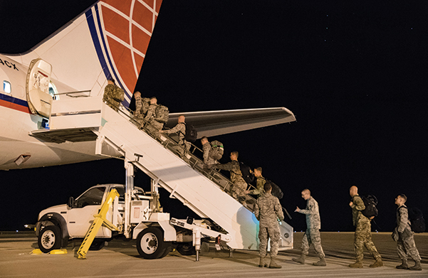 <em>Airmen board a civilian passenger jet (U.S. Air Force)</em>